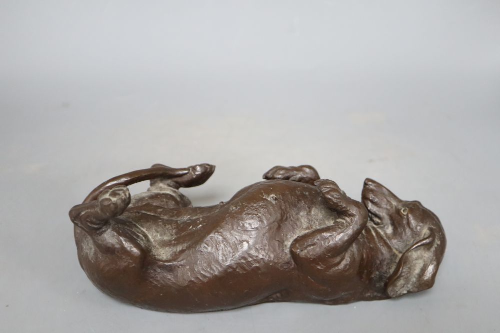 A composite figure of a recumbent dachshund, signed Doris Lindner, length 26cm